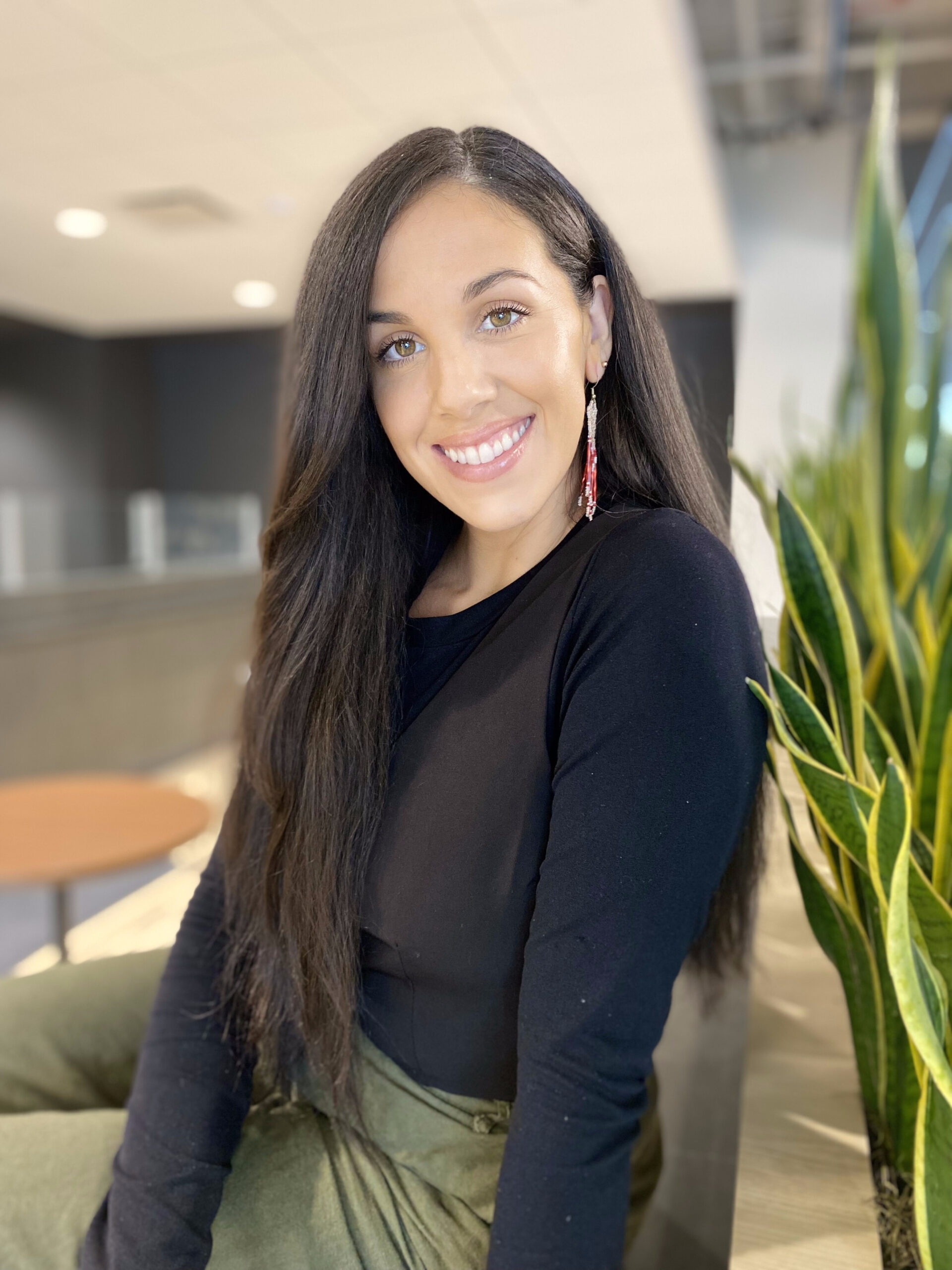Smiling NATIVation Counseling clinician with beaded earrings