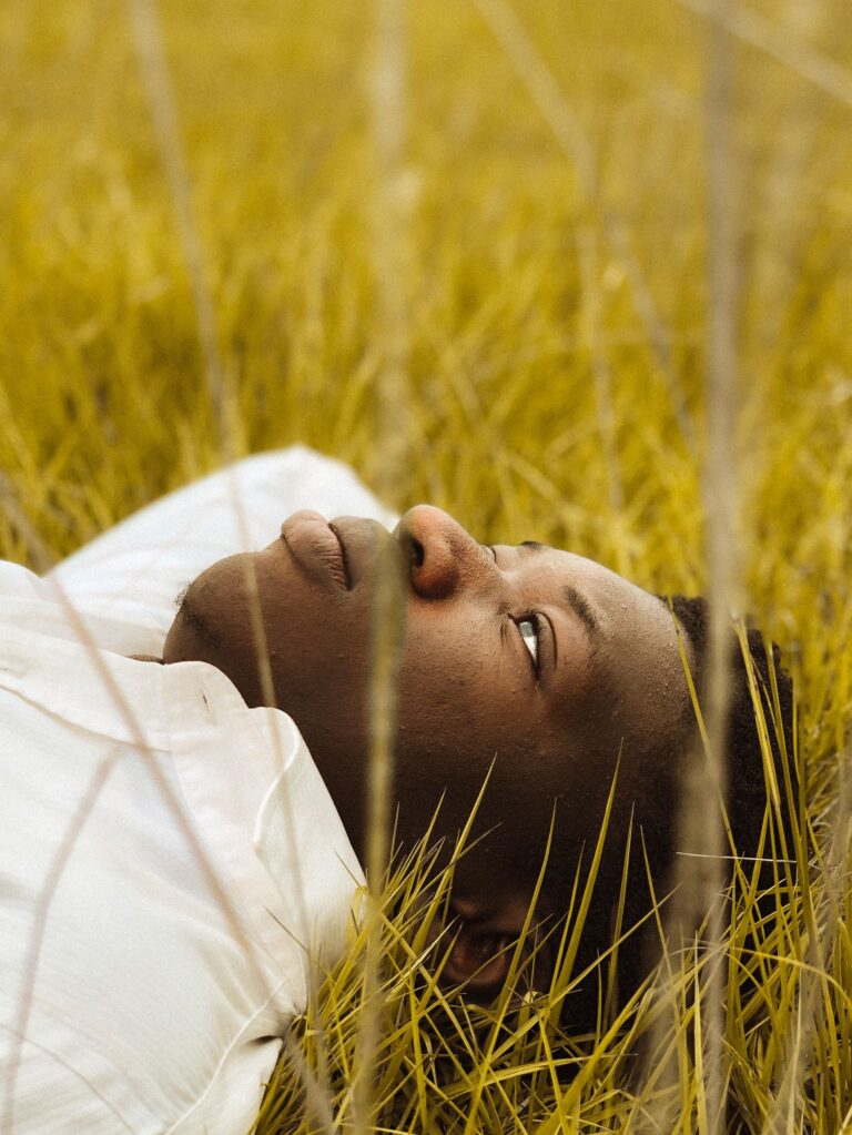 A person reclining with eyes closed in a calm, trauma-informed hypnotherapy session