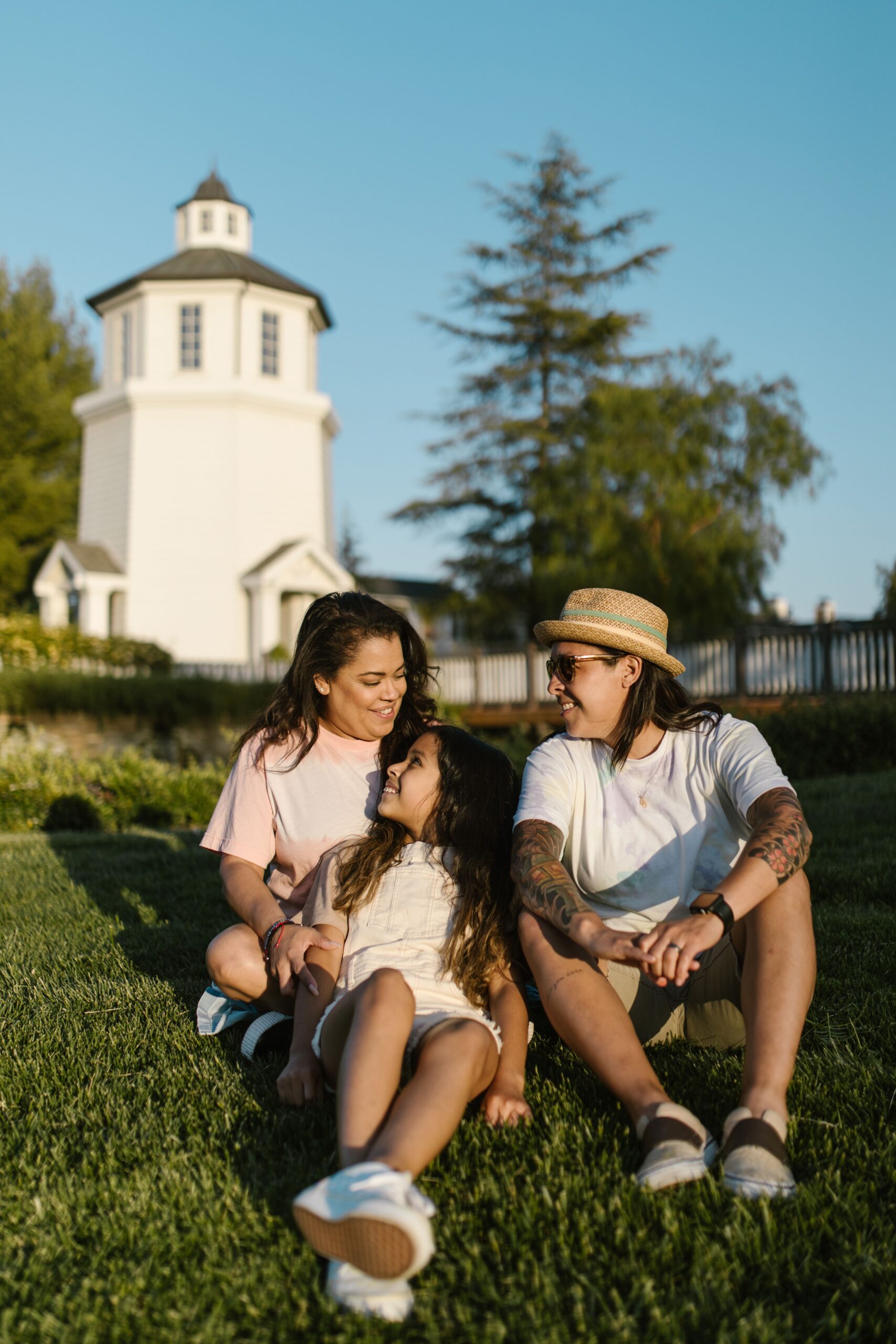 A family sitting together on the grass outdoors
